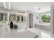 Bright bathroom featuring a soaking tub, white tiled floors, double sink and vanity, and a window overlooking greenery at 1552 Brentwood Dr, Marietta, GA 30062