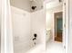 Bathroom showcasing a tub with shower, tiled walls, and modern fixtures at 1552 Brentwood Dr, Marietta, GA 30062