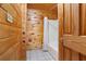 Full bathroom with white tiled floors and wood walls and trim at 1552 Brentwood Dr, Marietta, GA 30062