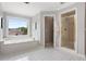 Well lit bathroom with garden tub, a glass-enclosed shower, and a window at 1552 Brentwood Dr, Marietta, GA 30062