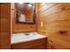 Bathroom featuring a white vanity, sink and mirror with wood walls and trim at 1552 Brentwood Dr, Marietta, GA 30062