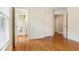 Bedroom featuring hardwood floors, three doors, and a double window at 1552 Brentwood Dr, Marietta, GA 30062
