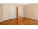 This bedroom features hardwood floors, a closet, neutral walls and an entrance to another room at 1552 Brentwood Dr, Marietta, GA 30062
