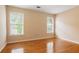 Empty bedroom with hardwood floors and a pair of windows providing plenty of natural light at 1552 Brentwood Dr, Marietta, GA 30062