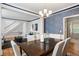Open-concept dining room and living room featuring a wooden table and staircase access at 1552 Brentwood Dr, Marietta, GA 30062