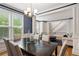 Elegant dining room with hardwood floors, large windows, and stylish light fixture at 1552 Brentwood Dr, Marietta, GA 30062