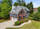 Charming two-story brick home with a two-car garage, beautiful landscaping, and a well-maintained lawn at 1552 Brentwood Dr, Marietta, GA 30062
