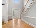Bright foyer featuring hardwood floors, a staircase with white railing, and a welcoming front door at 1552 Brentwood Dr, Marietta, GA 30062
