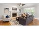 Bright living room showcasing a fireplace, hardwood floors, and large windows at 1552 Brentwood Dr, Marietta, GA 30062