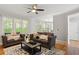 Comfortable living room with large windows, hardwood floors, and a ceiling fan at 1552 Brentwood Dr, Marietta, GA 30062