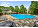A community pool with lounge chairs, tables, and shade, offering a relaxing oasis for residents to enjoy at 1552 Brentwood Dr, Marietta, GA 30062