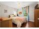 Cozy bedroom featuring hardwood floors, a chandelier, rainbow curtains, and plenty of natural light at 2069 Brightleaf Way # 123, Marietta, GA 30060