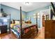 Comfortable bedroom with dark hardwood floors, four poster bed, and blue painted walls at 2069 Brightleaf Way # 123, Marietta, GA 30060