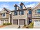 Brick townhouse with two-car garage, shutters, dormers, and manicured front garden at 2069 Brightleaf Way # 123, Marietta, GA 30060