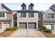 Charming brick townhouse featuring a two-car garage, dormers, and well-maintained landscaping at 2069 Brightleaf Way # 123, Marietta, GA 30060