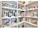 Walk-in pantry with white shelving and various food items at 2069 Brightleaf Way # 123, Marietta, GA 30060