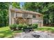 A spacious backyard with a lush lawn, a deck, patio seating, a shed, and mature trees at 300 Alcovy Way, Covington, GA 30014