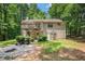 Wide backyard showing a lush green lawn, the back deck, a patio seating area, a shed, and wooded perimeter at 300 Alcovy Way, Covington, GA 30014