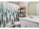 Bathroom featuring a curtain with trees, a sink, and shelves for storage at 300 Alcovy Way, Covington, GA 30014