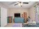 Bedroom featuring a ceiling fan, a dresser with a TV, and moving boxes at 300 Alcovy Way, Covington, GA 30014