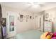 Cozy bedroom boasts decor, a full length mirror, adjacent bathroom and well placed artwork on the walls at 300 Alcovy Way, Covington, GA 30014