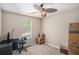 Bedroom featuring a ceiling fan, large window, and moving boxes at 300 Alcovy Way, Covington, GA 30014