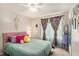 Bedroom showcasing charming decor, ceiling fan and ample natural light at 300 Alcovy Way, Covington, GA 30014