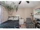 Bedroom featuring a ceiling fan, shelves, hanging vines, and cozy chair at 300 Alcovy Way, Covington, GA 30014