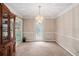 Bright dining room with modern lighting, seamless flow to the kitchen, and access to the outdoors at 300 Alcovy Way, Covington, GA 30014