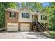 Charming split-level home with stone accents, two-car garage, and inviting front entrance surrounded by mature trees at 300 Alcovy Way, Covington, GA 30014