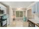 Bright eat-in kitchen with stainless steel appliances, white cabinetry, and a window offering natural light at 300 Alcovy Way, Covington, GA 30014