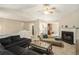 Inviting living room featuring a fireplace, plush sofa, chaise lounge, with seamless flow into the adjacent dining area at 300 Alcovy Way, Covington, GA 30014