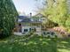 Back exterior view of home featuring deck, patio, fire pit and beautifully landscaped yard at 4584 E Conway Nw Dr, Atlanta, GA 30327