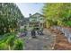 Lush backyard with gravel patio including firepit and wooden lounge chairs at 4584 E Conway Nw Dr, Atlanta, GA 30327
