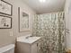 Bathroom with a floral shower curtain and white vanity, providing a fresh and clean space at 4584 E Conway Nw Dr, Atlanta, GA 30327