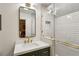 Modern bathroom featuring white subway tile in shower, a sleek mirror, and stylish gold fixtures at 4584 E Conway Nw Dr, Atlanta, GA 30327