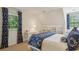 Bright bedroom featuring blue and white accents, large windows, and a comfortable seating area at 4584 E Conway Nw Dr, Atlanta, GA 30327