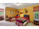 Rustic bedroom with log walls, twin beds, and mounted deer heads for a cozy, cabin-like feel at 4584 E Conway Nw Dr, Atlanta, GA 30327