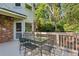 Outdoor deck with dining table, chairs, and backyard access at 4584 E Conway Nw Dr, Atlanta, GA 30327