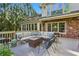 Spacious outdoor deck with comfortable seating, brick accents, and string lights at 4584 E Conway Nw Dr, Atlanta, GA 30327