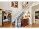 Elegant foyer with a chandelier and staircase, enhanced by hardwood floors and a view into the dining room at 4584 E Conway Nw Dr, Atlanta, GA 30327