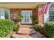 Inviting brick pathway leading to the front door, complemented by well-maintained landscaping and greenery at 4584 E Conway Nw Dr, Atlanta, GA 30327