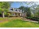 Classic brick home with dormer windows and impeccable landscaping on a lush green lot at 4584 E Conway Nw Dr, Atlanta, GA 30327