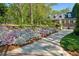 Brick home boasts immaculate landscaping with flower lined driveway at 4584 E Conway Nw Dr, Atlanta, GA 30327