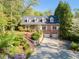 Charming brick home featuring a manicured lawn, beautiful landscaping and a private two-car garage at 4584 E Conway Nw Dr, Atlanta, GA 30327