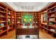 Stunning home office with custom built-in bookshelves, large desk, and a serene view from the window at 4584 E Conway Nw Dr, Atlanta, GA 30327