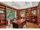 Handsome home office boasting custom built-in bookshelves, hardwood floors, and an elegant writing desk at 4584 E Conway Nw Dr, Atlanta, GA 30327
