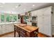 Spacious kitchen with an island, stainless appliances, white cabinets, and hardwood floors at 4584 E Conway Nw Dr, Atlanta, GA 30327