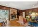 Warm living room features a stone fireplace, wood paneling, and comfortable seating for relaxation at 4584 E Conway Nw Dr, Atlanta, GA 30327