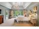 Spacious main bedroom with tray ceiling, French doors to balcony, ensuite bath, and custom floral touches at 4584 E Conway Nw Dr, Atlanta, GA 30327